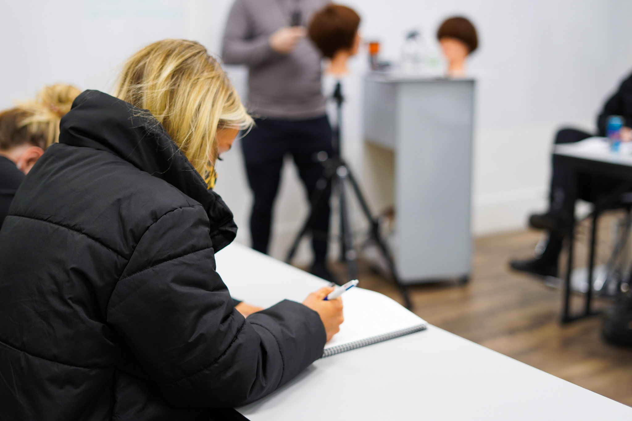 woman taking notes in class at collectiv academy