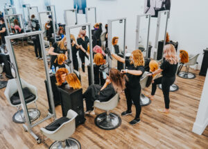 A overhead view of a salon with stylists and clients