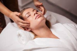 Woman hacing a facial done in a spa