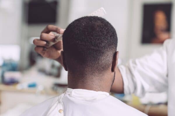 man getting his hair styled at a barbershop